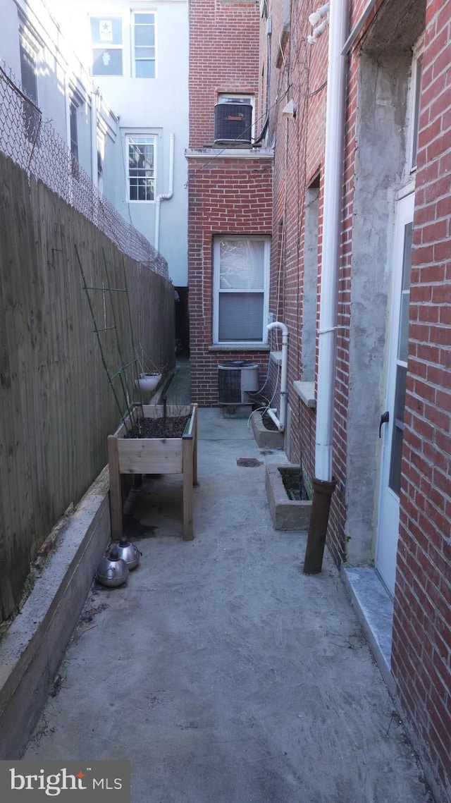 view of patio / terrace featuring central AC unit and fence