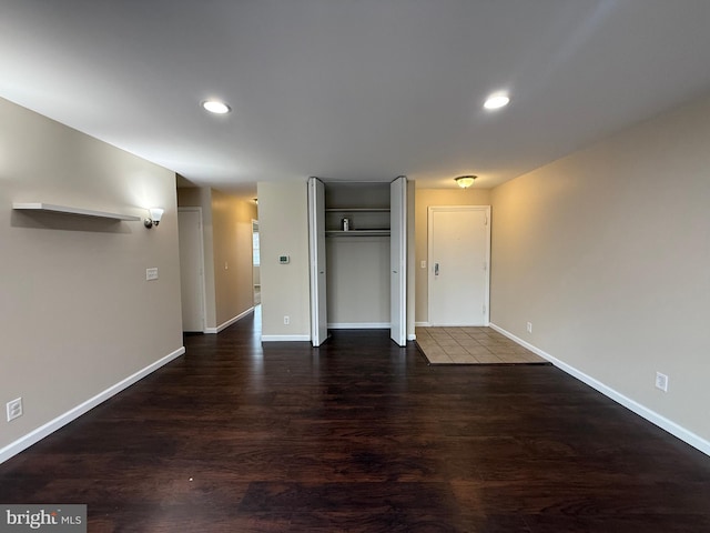 unfurnished living room featuring recessed lighting, wood finished floors, and baseboards