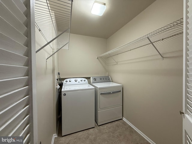 washroom featuring laundry area, carpet, independent washer and dryer, and baseboards