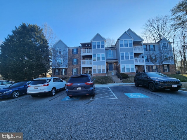 view of building exterior featuring uncovered parking