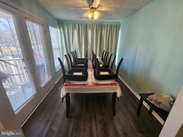 dining area featuring baseboards, a textured ceiling, wood finished floors, and a ceiling fan