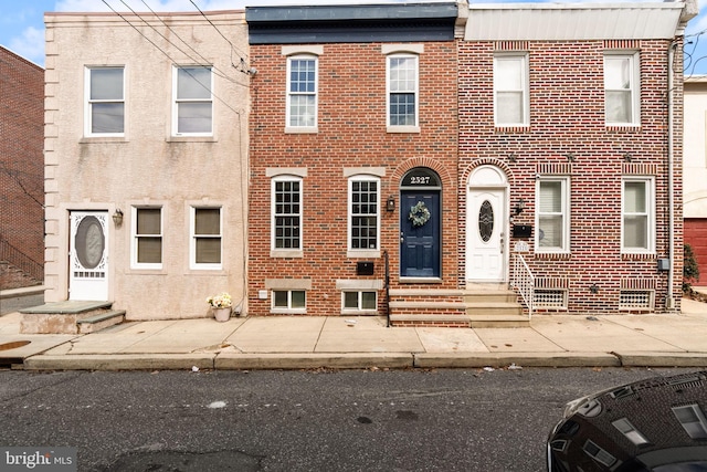 multi unit property with entry steps and brick siding