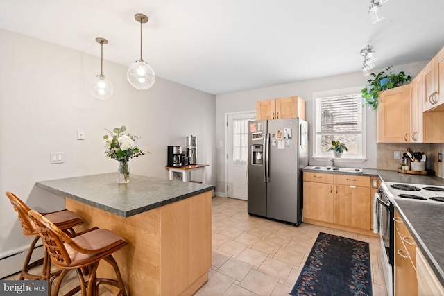 kitchen featuring stainless steel fridge, dark countertops, light brown cabinetry, and electric stove