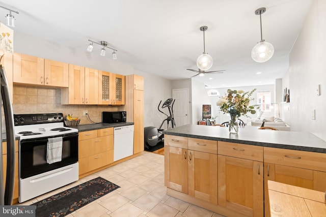 kitchen featuring dark countertops, electric stove, black microwave, and white dishwasher