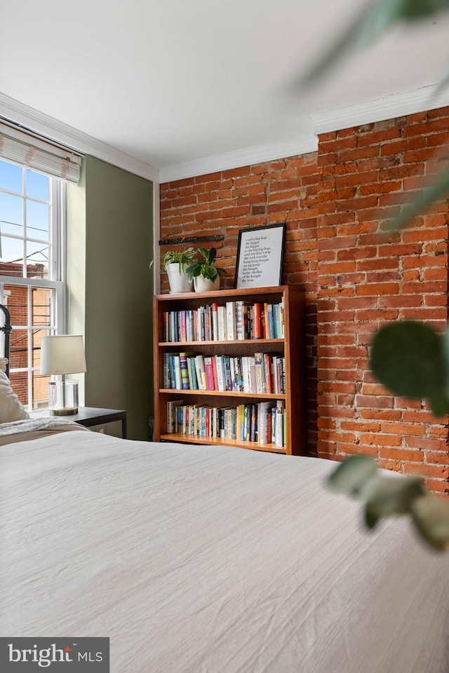 unfurnished bedroom with brick wall and crown molding