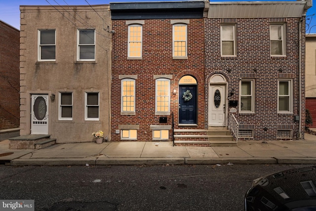 view of property featuring brick siding and entry steps