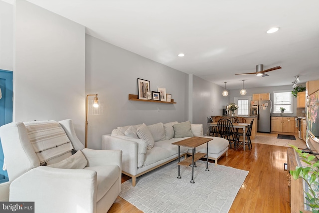 living room featuring recessed lighting, light wood-style flooring, and ceiling fan