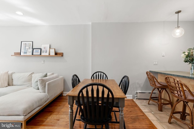 dining room with recessed lighting, light wood-style floors, and baseboard heating