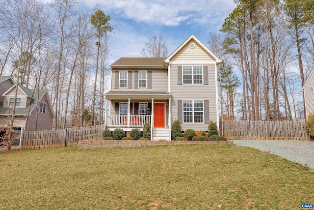 traditional home with a porch, a front lawn, and fence