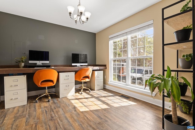 office space featuring visible vents, baseboards, a notable chandelier, and wood finished floors