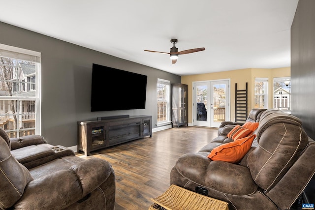 living room with wood finished floors, baseboards, french doors, and ceiling fan