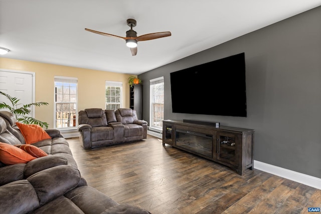 living area featuring a ceiling fan, wood finished floors, and baseboards