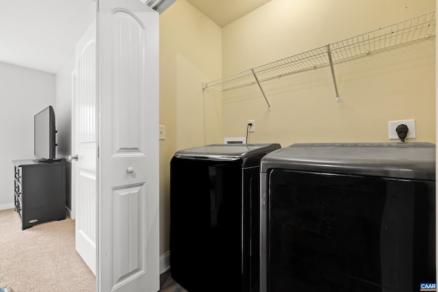 laundry room featuring laundry area, washing machine and dryer, baseboards, and carpet