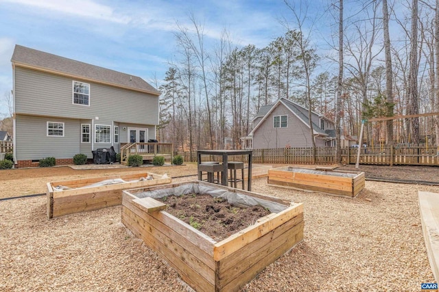 view of yard with a garden, a deck, and fence