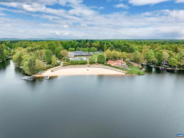 drone / aerial view featuring a forest view and a water view