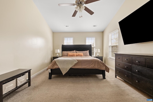 bedroom with visible vents, light colored carpet, and baseboards