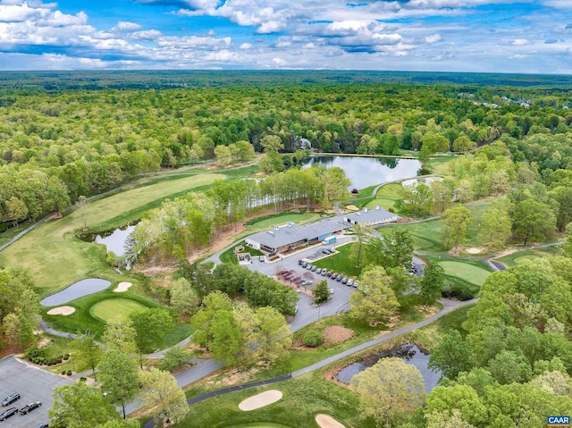 bird's eye view with golf course view, a wooded view, and a water view