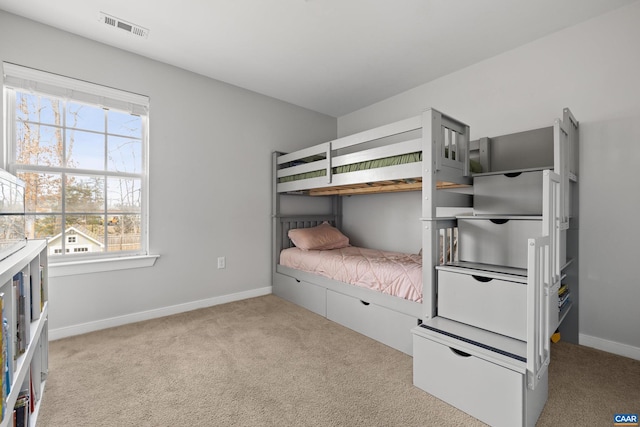 bedroom featuring visible vents, baseboards, and carpet