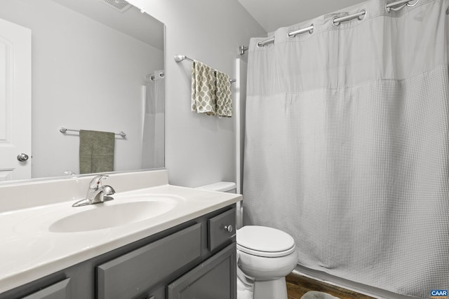 full bath with a shower with curtain, toilet, wood finished floors, and vanity