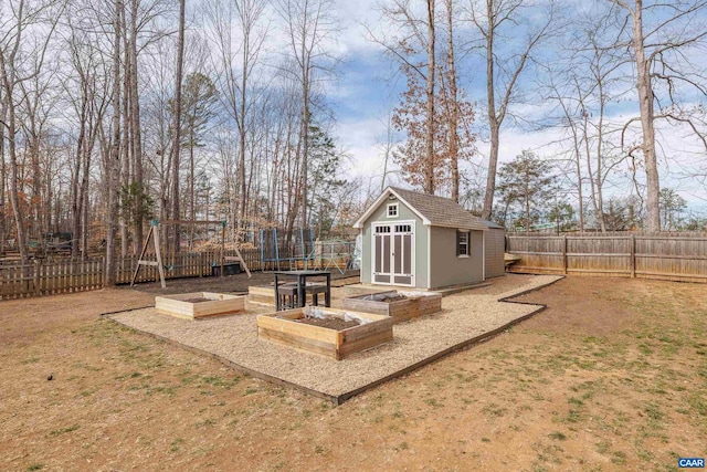 view of shed featuring a garden and a fenced backyard