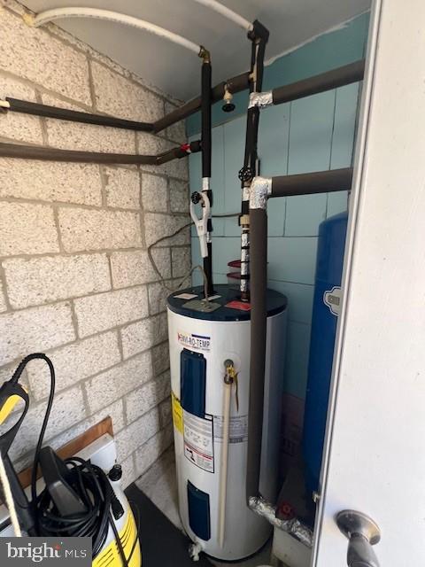 utility room with electric water heater