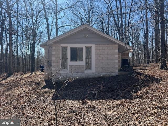 view of side of home featuring concrete block siding