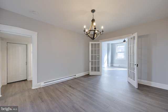 unfurnished dining area with a baseboard heating unit, baseboards, french doors, wood finished floors, and a baseboard radiator