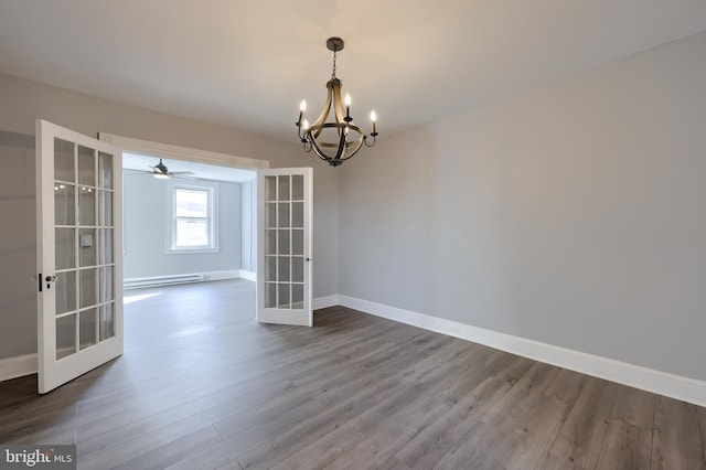 spare room featuring a baseboard radiator, french doors, dark wood-style flooring, and baseboards