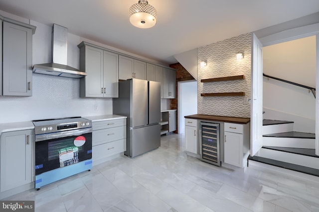 kitchen with wine cooler, gray cabinets, stainless steel appliances, wall chimney exhaust hood, and open shelves