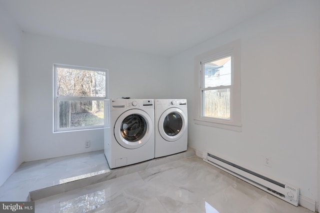 laundry room featuring a baseboard radiator, a healthy amount of sunlight, laundry area, and washing machine and clothes dryer