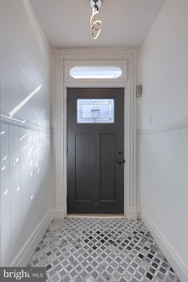 foyer with light floors and wainscoting