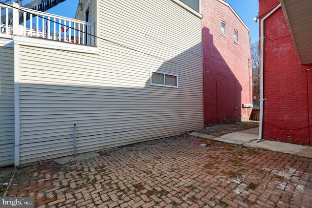 view of home's exterior with a balcony