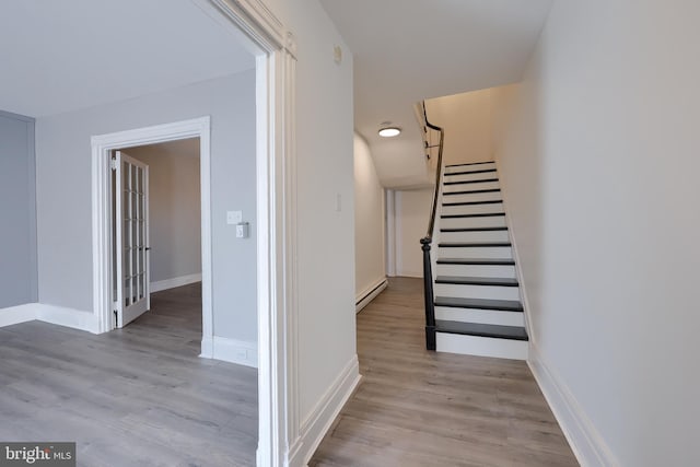 interior space with wood finished floors, baseboards, and baseboard heating