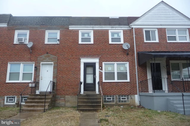 view of property with entry steps and brick siding