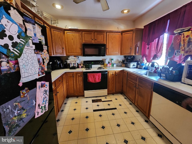 kitchen featuring black appliances, a ceiling fan, a sink, brown cabinetry, and light countertops