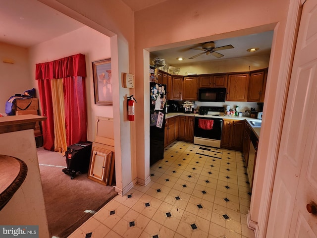 kitchen with black appliances, a ceiling fan, a sink, recessed lighting, and light countertops