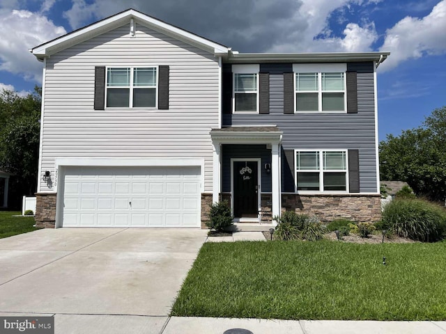 view of front facade with concrete driveway, a garage, stone siding, and a front yard