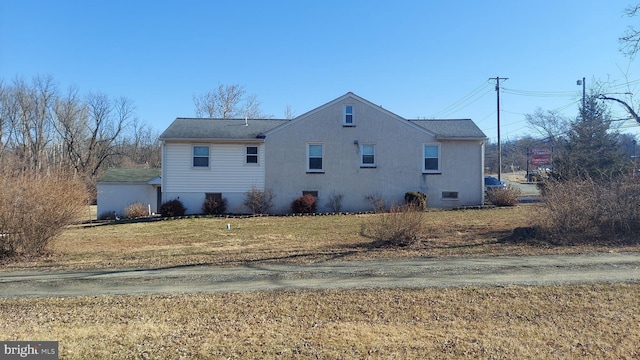 view of property exterior with a yard