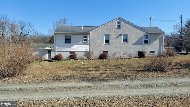 view of side of property featuring a yard