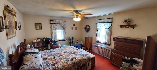 bedroom with radiator, dark carpet, and ceiling fan