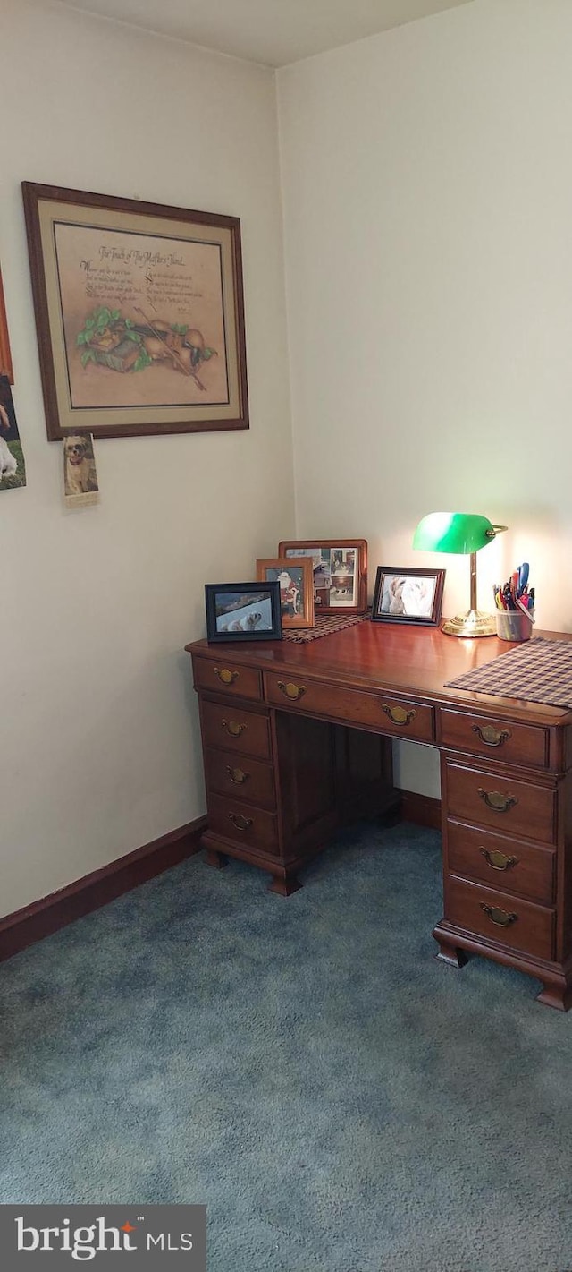 office space featuring baseboards and dark carpet