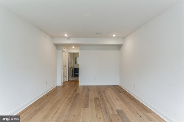 spare room with visible vents, recessed lighting, baseboards, and light wood-style floors