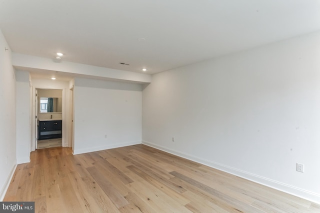 empty room featuring visible vents, recessed lighting, baseboards, and light wood-type flooring