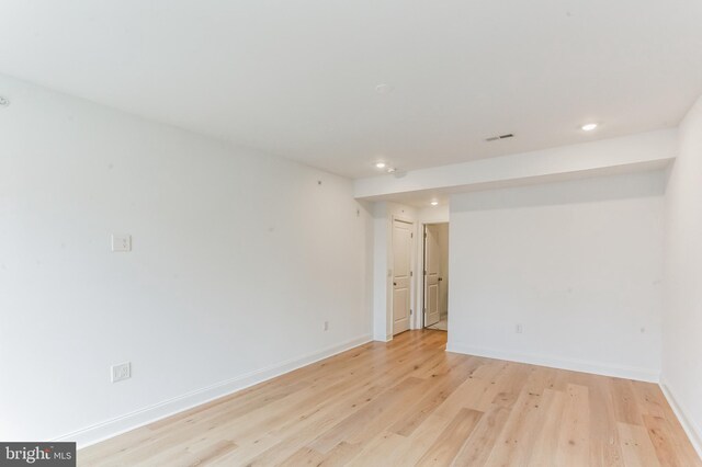 empty room with recessed lighting, light wood-style floors, and baseboards