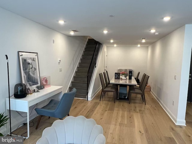 dining room featuring recessed lighting, baseboards, light wood-style floors, and stairs