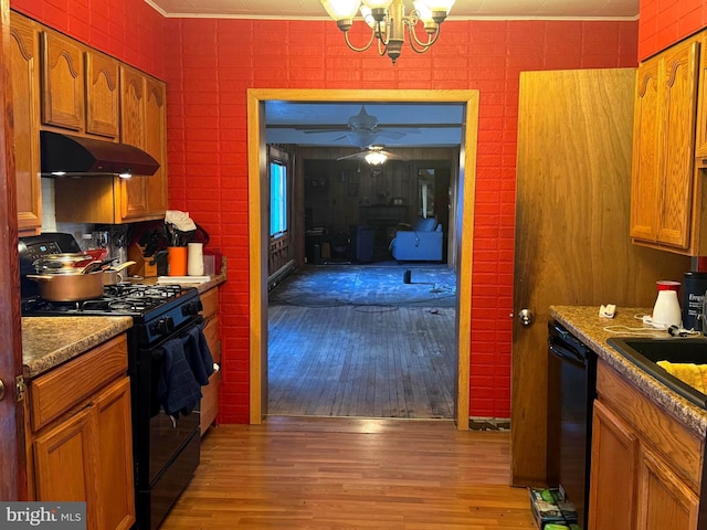 kitchen featuring brown cabinetry, black appliances, under cabinet range hood, crown molding, and light wood-type flooring