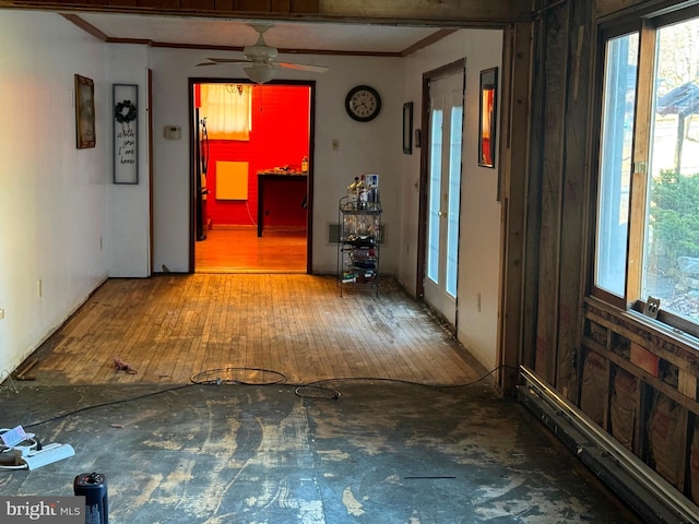 interior space featuring crown molding, a ceiling fan, and wood-type flooring