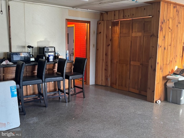 bar with speckled floor and wood walls