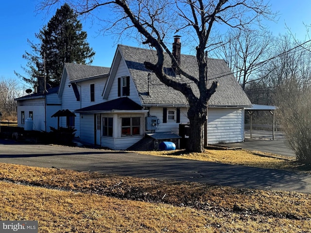 view of front facade featuring a chimney