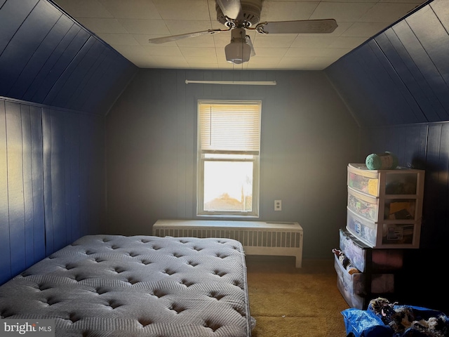 bedroom with radiator, carpet, a ceiling fan, and vaulted ceiling